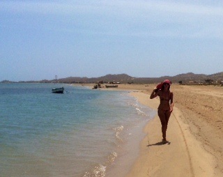Emma walking along the beach, when she's not sailing around the world