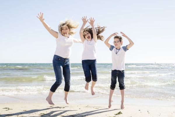Erin Holmes and family on the beach, loving the travel lifestyle!