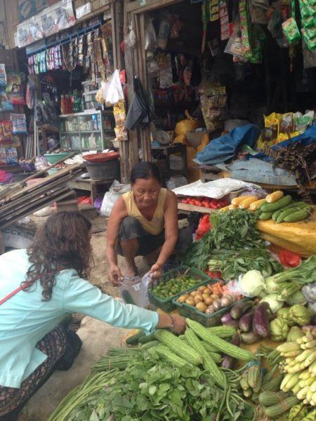 Morgan Pettersson buying veggies at the market in Sulawesi