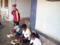 Kids eating in India; photo by Nomadic Chick