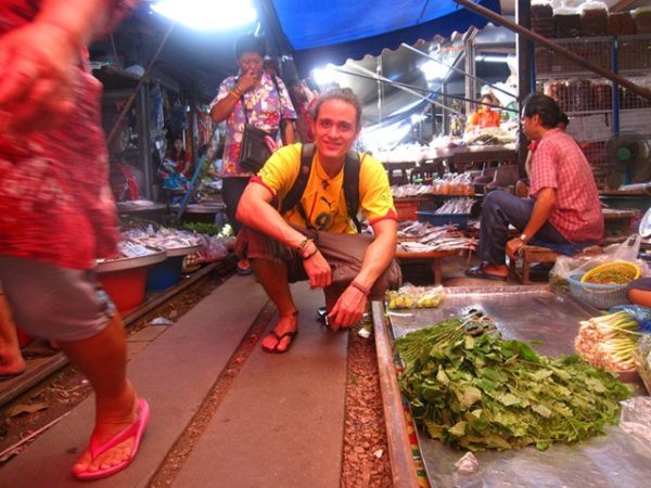 Migration Mark of Migrationology at Maeklong Train Market in Bangkok