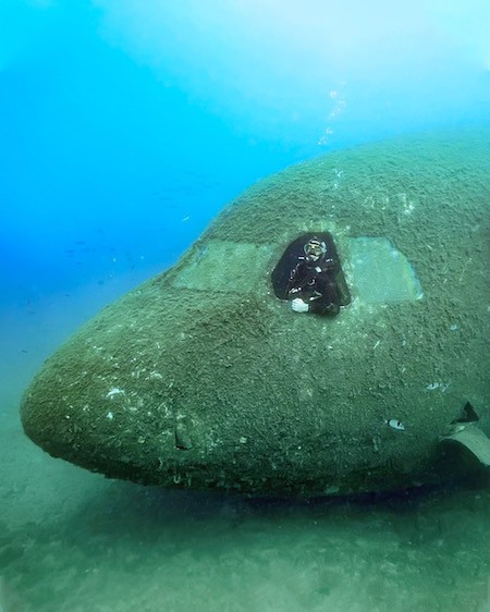 Mike Corey scuba diving in an airplane