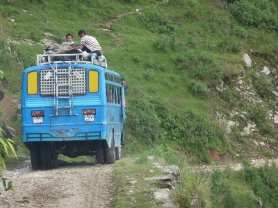 blue bus in india on narrow mountain road