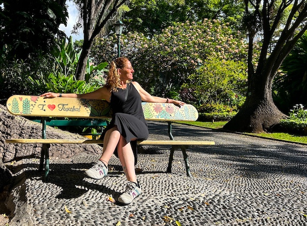Nora Dunn of The Professional Hobo, sitting on a bench that says I Love Funchal Nora Dunn of The Professional Hobo, sitting on a bench that says I Love Funchal