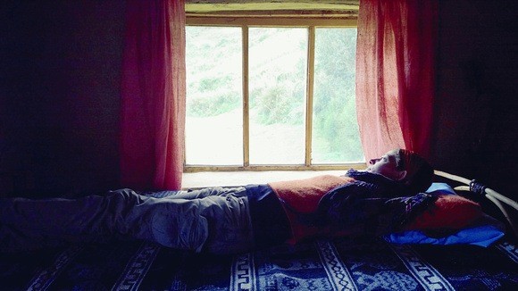 resting and looking out the window in the home of my Quechua mama