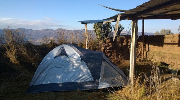 camping under an informal shelter in the Andes