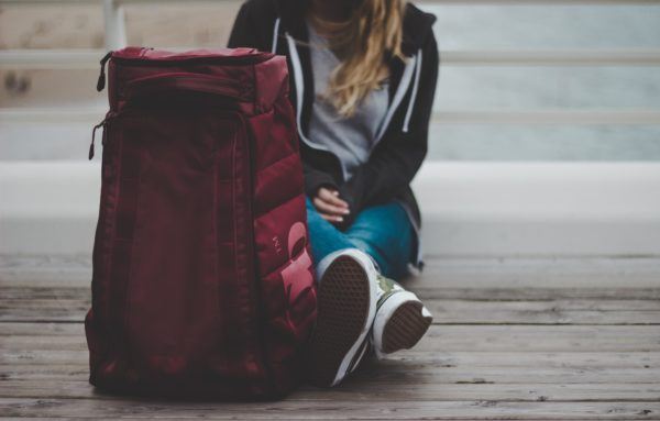 girl with suitcase making money while traveling