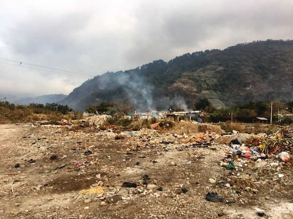 Burning garbage on the riverbanks of Panajachel Guatemala. My travel mistake was booking accommodation in the wrong place.